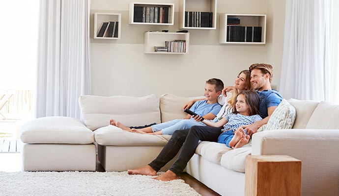 family sitting on a sofa in a clean room