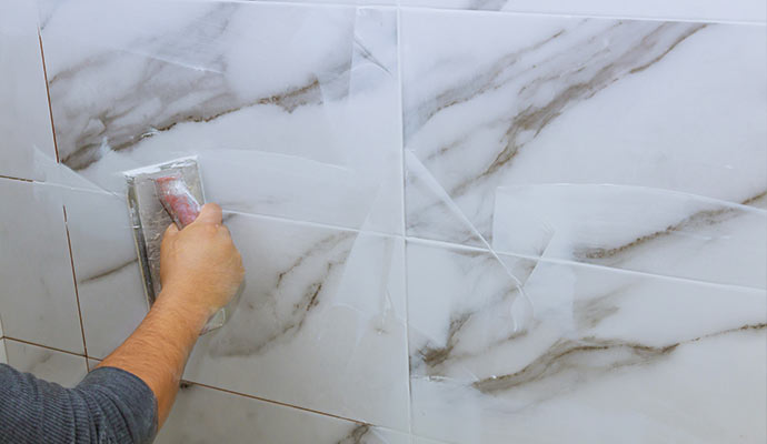 a professional sealing grout between tiles