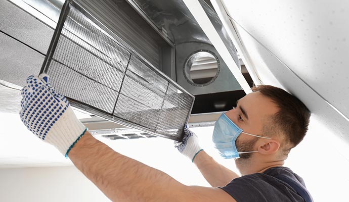 Person cleaning air duct