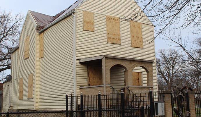 a house with boarded up windows and doors