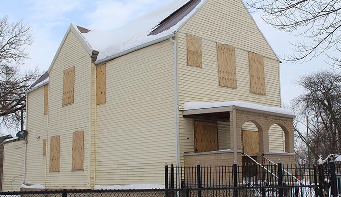 A house with boarded up windows and doors