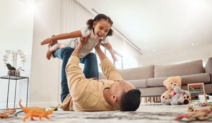 Man playing with a child in a room